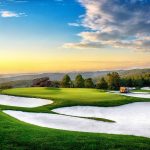 Panoramic view of a lush green golf course at Top of the Rock Golf Course. Smooth