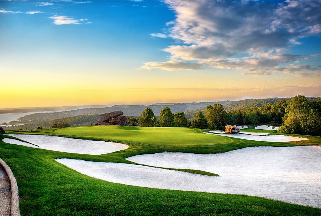 Panoramic view of a lush green golf course at Top of the Rock Golf Course. Smooth