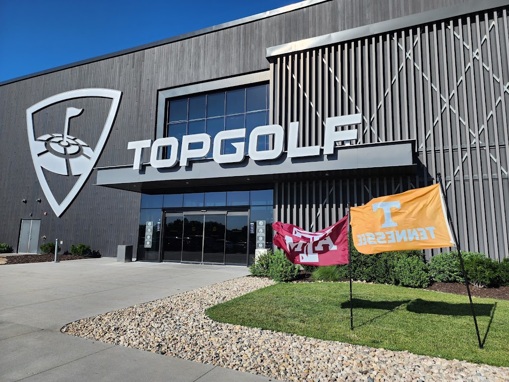 Panoramic view of a lush green golf course at Topgolf. Smooth