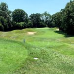 Panoramic view of a lush green golf course at Town of Oyster Bay Golf Course. Smooth