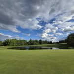 Panoramic view of a lush green golf course at Traditions Golf Club. Smooth