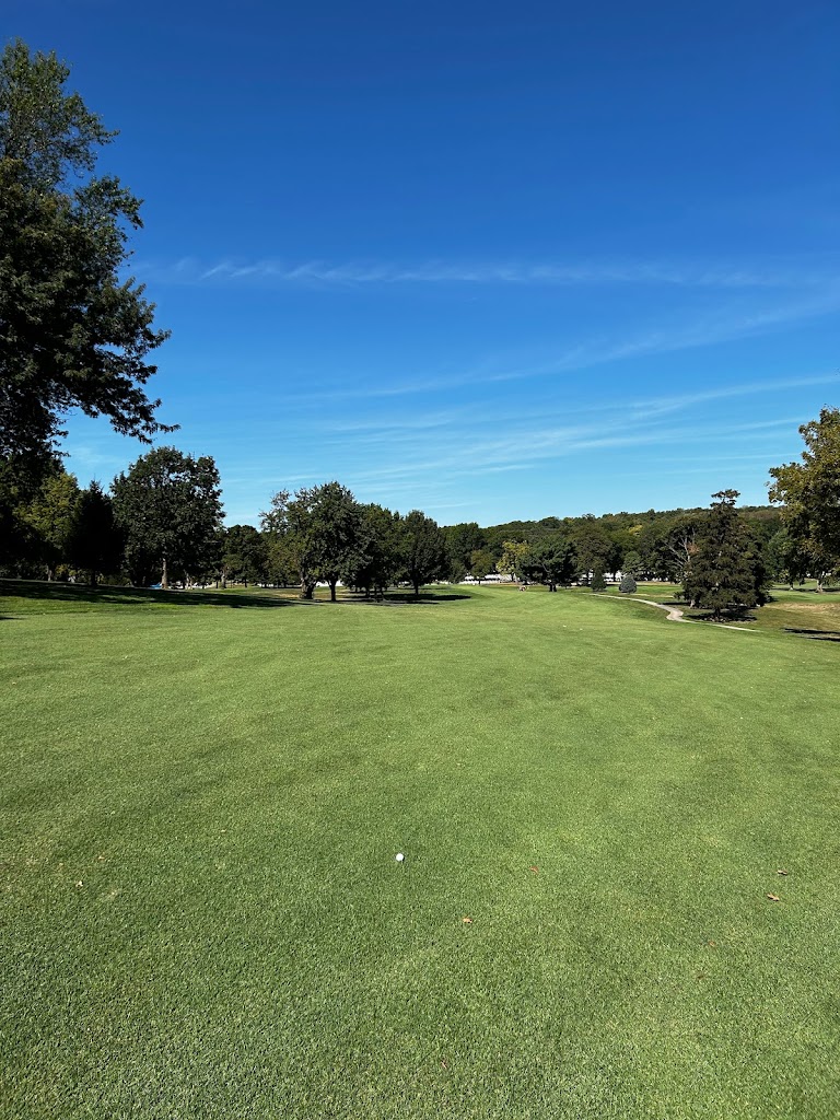 Panoramic view of a lush green golf course at Trails West Golf Course. Smooth