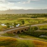 Panoramic view of a lush green golf course at Tributary. Smooth