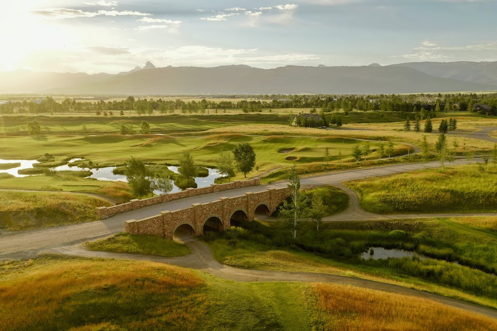 Panoramic view of a lush green golf course at Tributary. Smooth