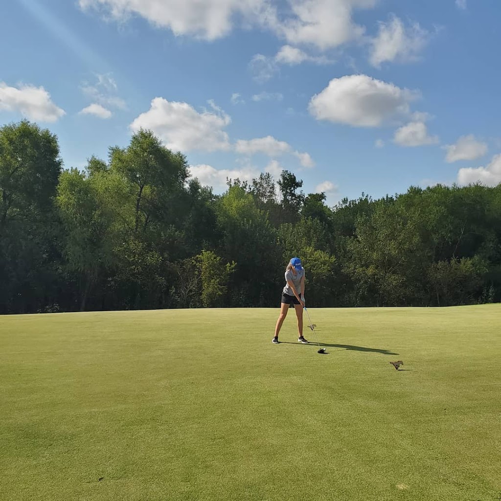 Panoramic view of a lush green golf course at Trinity Forest Golf Club. Smooth