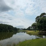 Panoramic view of a lush green golf course at True Blue Golf Club. Smooth