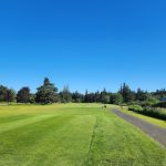 Panoramic view of a lush green golf course at Tumwater Valley Golf Club. Smooth