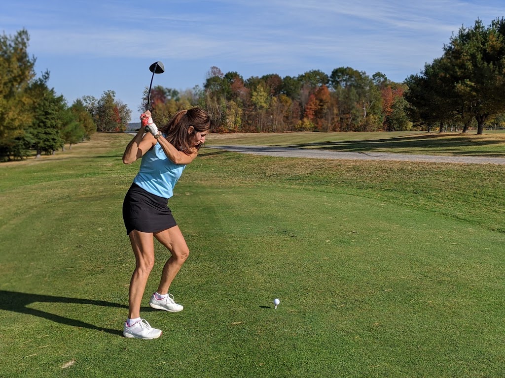 Panoramic view of a lush green golf course at Turner Highlands Golf Course. Smooth