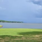 Panoramic view of a lush green golf course at Turtle Point. Smooth