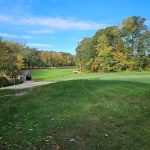Panoramic view of a lush green golf course at Twin Hills Country Club. Smooth