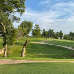 Panoramic view of a lush green golf course at Twin Hills Golf & Country Club. Smooth