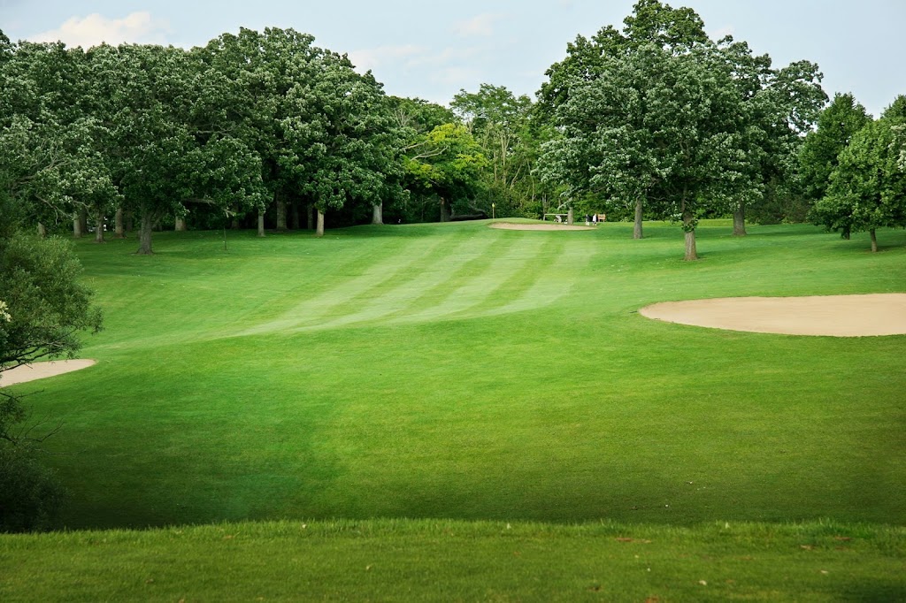 Panoramic view of a lush green golf course at Twin Lakes Country Club. Smooth