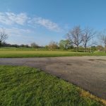 Panoramic view of a lush green golf course at Twin Lakes Golf Club. Smooth