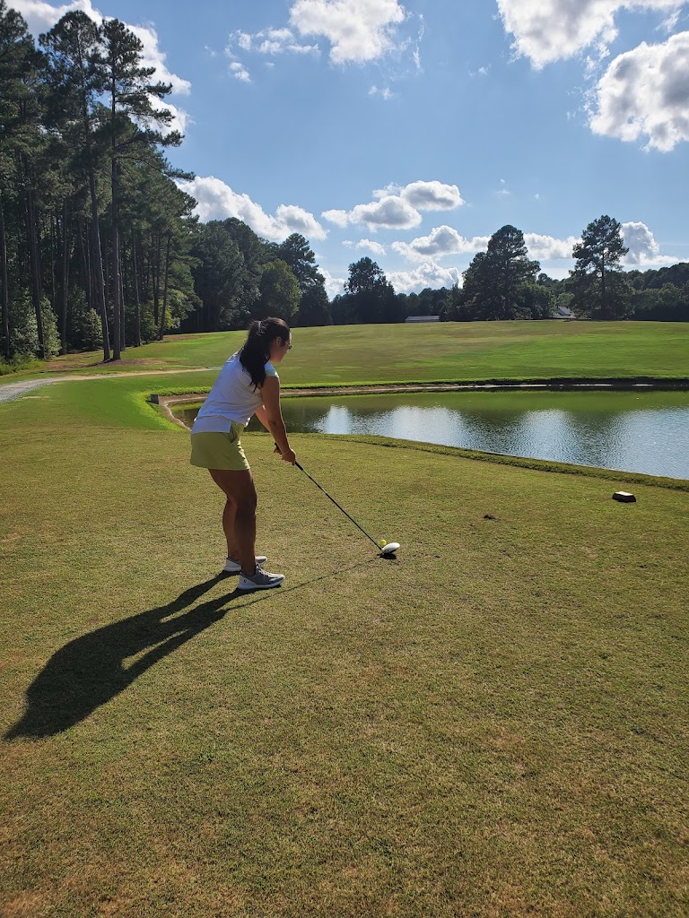 Panoramic view of a lush green golf course at Twin Lakes Golf Course. Smooth