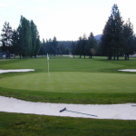 Panoramic view of a lush green golf course at Twin Lakes Village Golf Club. Smooth