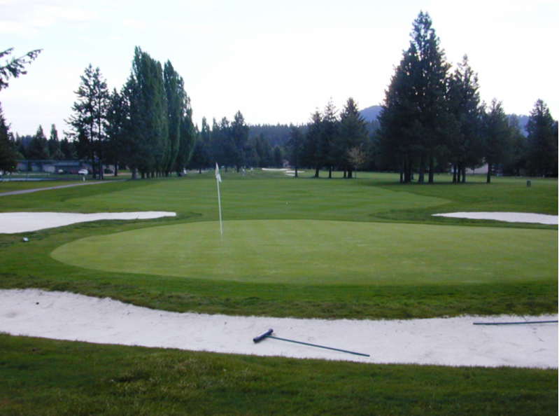Panoramic view of a lush green golf course at Twin Lakes Village Golf Club. Smooth