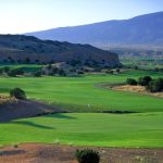 Panoramic view of a lush green golf course at Twin Warriors Golf Club. Smooth