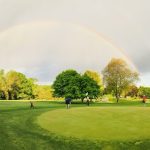 Panoramic view of a lush green golf course at Twin Willows Par 3 Golf. Smooth
