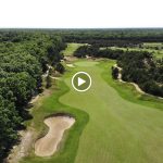 Panoramic view of a lush green golf course at Twisted Dune Golf Club. Smooth