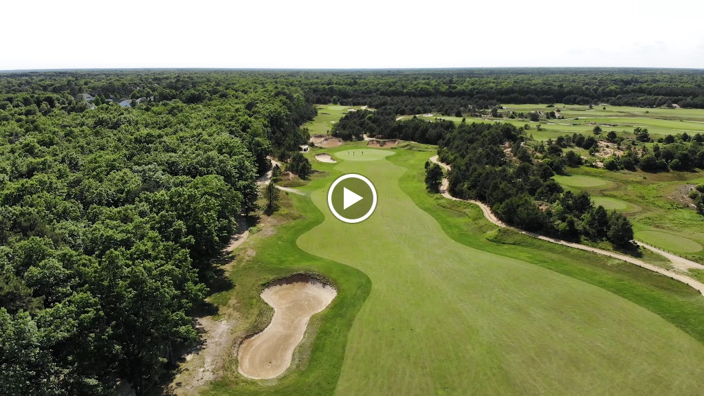 Panoramic view of a lush green golf course at Twisted Dune Golf Club. Smooth