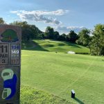 Panoramic view of a lush green golf course at Two Rivers Golf Course. Smooth