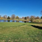 Panoramic view of a lush green golf course at University Club of Kentucky. Smooth