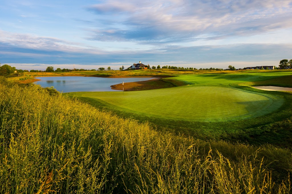 Panoramic view of a lush green golf course at University of Louisville Golf Club. Smooth
