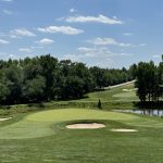 Panoramic view of a lush green golf course at University of Maryland Golf Course. Smooth
