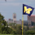 Panoramic view of a lush green golf course at University of Michigan Golf Course. Smooth