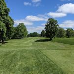Panoramic view of a lush green golf course at University of Minnesota