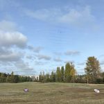 Panoramic view of a lush green golf course at University of Washington Golf Range. Smooth