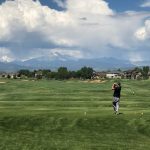 Panoramic view of a lush green golf course at Ute Creek Golf Course. Smooth