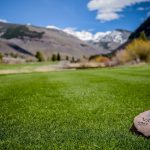 Panoramic view of a lush green golf course at Vail Golf Club. Smooth