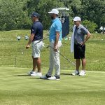 green grass with the flag in the hole.