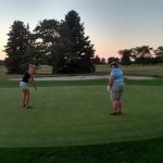 green grass with the flag in the hole.