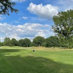 Panoramic view of a lush green golf course at Vanderbilt Legends Club. Smooth