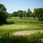 Panoramic view of a lush green golf course at Veenker Memorial Golf Course. Smooth