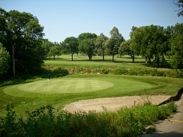 Panoramic view of a lush green golf course at Veenker Memorial Golf Course. Smooth