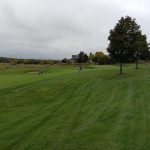 Panoramic view of a lush green golf course at Vermont National Country Club. Smooth