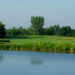 Panoramic view of a lush green golf course at Victory Links Golf Course. Smooth