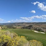 Panoramic view of a lush green golf course at Victory Ranch Golf Club. Smooth