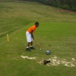 green grass with the flag in the hole.