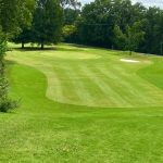 Panoramic view of a lush green golf course at VinnyLinks Golf Course. Smooth