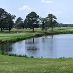 Panoramic view of a lush green golf course at Virginia Beach National Golf Club. Smooth