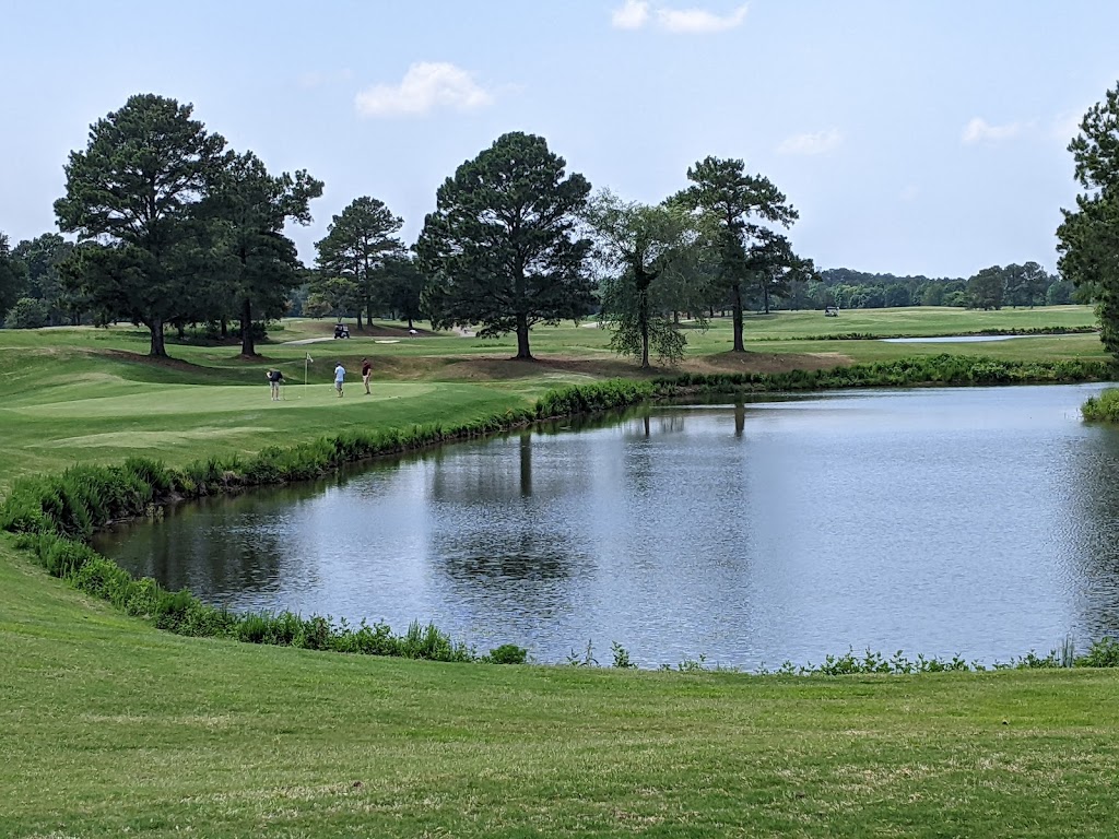 Panoramic view of a lush green golf course at Virginia Beach National Golf Club. Smooth