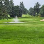 Panoramic view of a lush green golf course at Viroqua Hills Golf Course. Smooth