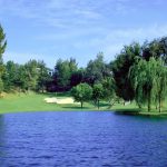 Panoramic view of a lush green golf course at Vista Valencia Golf Course. Smooth