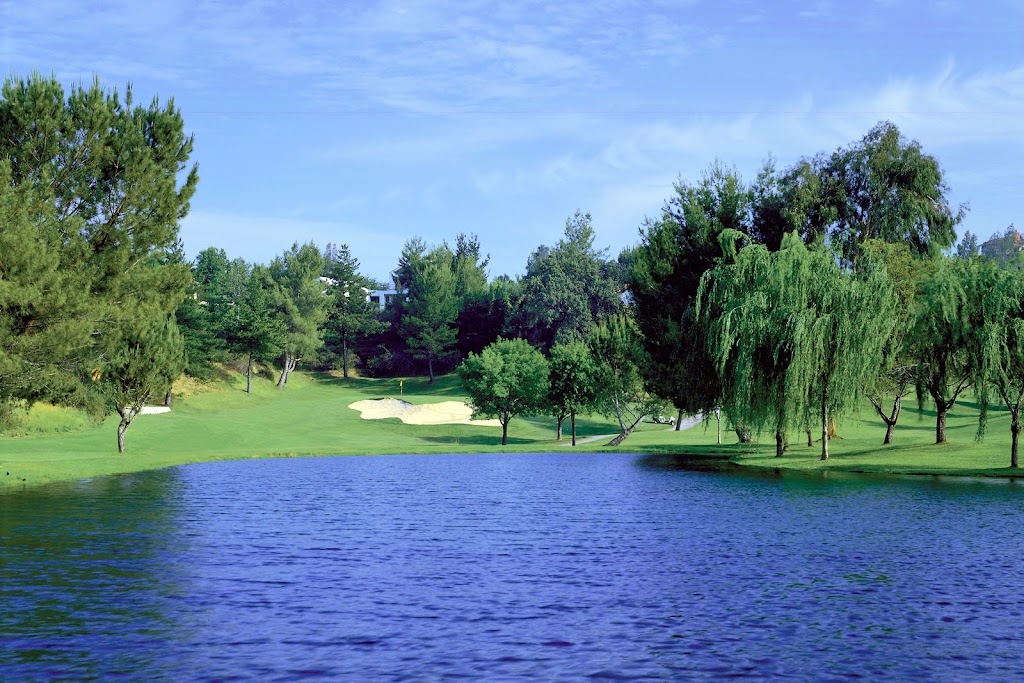 Panoramic view of a lush green golf course at Vista Valencia Golf Course. Smooth