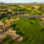 Panoramic view of a lush green golf course at Vistas Course at Westbrook Village Golf Club. Smooth