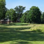 Panoramic view of a lush green golf course at Warren Golf Course. Smooth